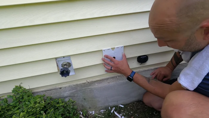 Fit the mounting block into the hole, ensuring sufficient clearance for siding movement. Make adjustments as needed.