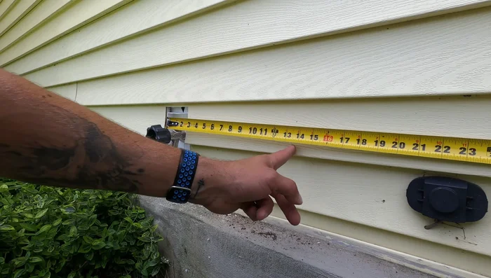 Measure and mark the location for the receptacle. Ensure it aligns with existing outdoor fixtures for a clean look.