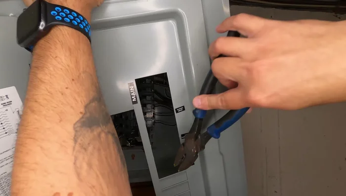 Replace the electrical panel cover and label the new breaker.