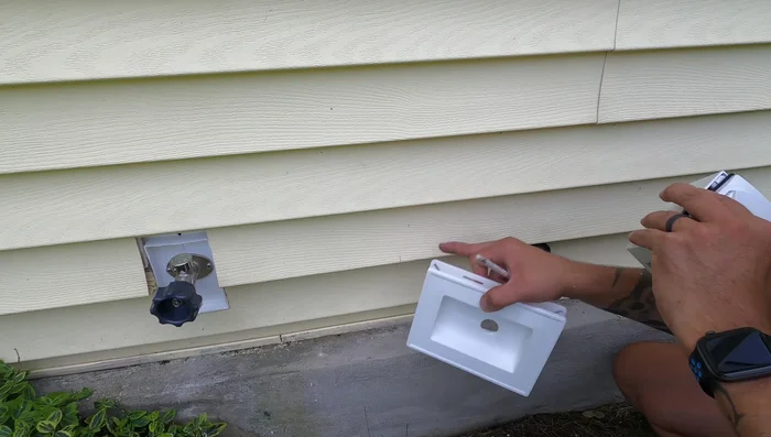 Fit the mounting block into the hole, ensuring sufficient clearance for siding movement. Make adjustments as needed.