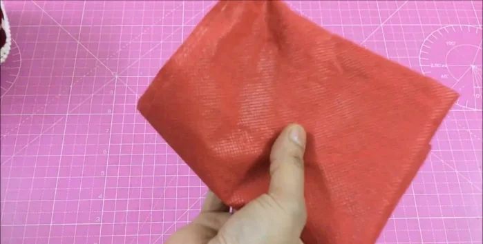 Measure the basket's volume. Use a fabric shopping bag of similar size, cutting it to fit above the basket's top. Glue the edges and insert into the basket, gluing the ends.