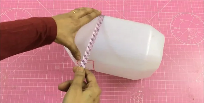 Measure the gallon's circumference (22 inches) and depth (3.5 inches + 1.5 inches extra).