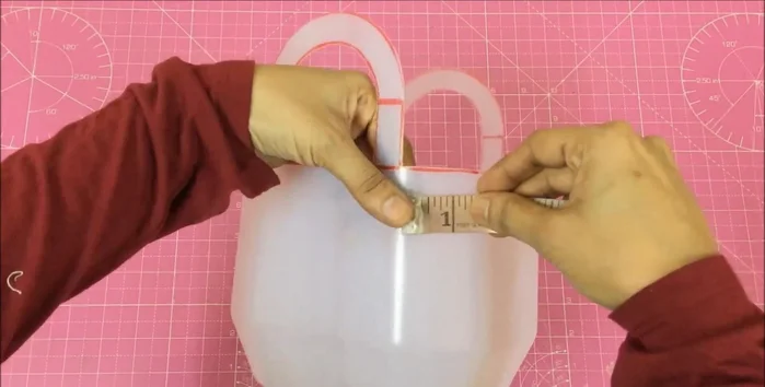Measure the gallon's circumference (22 inches) and depth (3.5 inches + 1.5 inches extra).