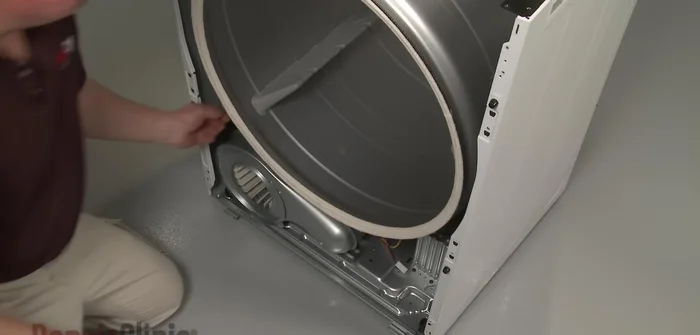 Remove the old roller and prepare the new one by transferring the washer.