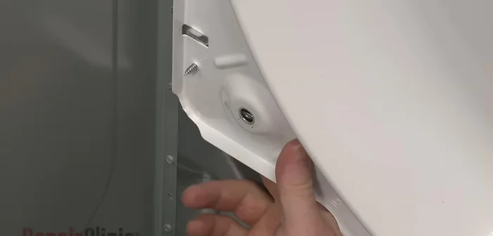 Slide the belt over the drum rib side down and replace the drum, looping the belt around the idler and motor pulleys.