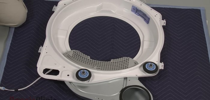 Access and remove the nuts securing the roller shaft, replace the roller, and then reposition the duct, securing it with screws and replacing the lint filter.