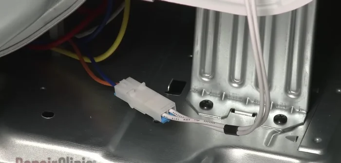 Reconnect the moisture sensor wire harness and light switch wire harness. Replace the front panel and secure it with screws.