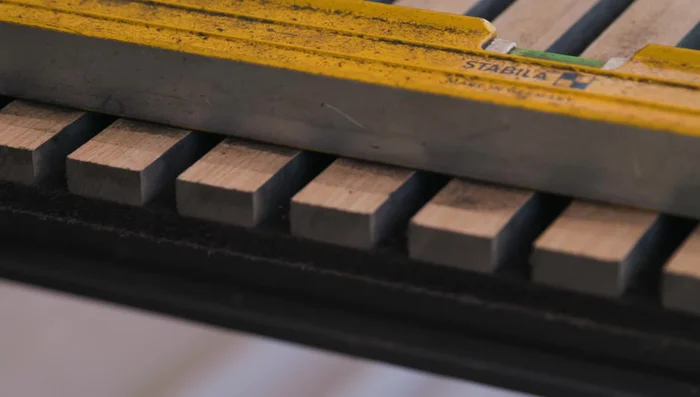 Remove masking tape and clean off any residue. Sand edges with 120-150 grit sandpaper for a smooth finish.