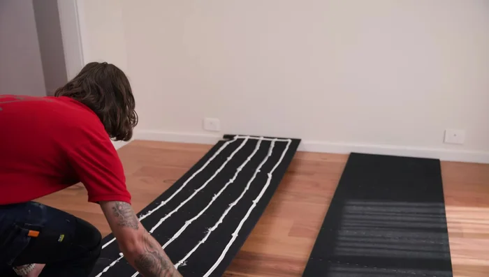 Screw button head screws through the felt into the wall.