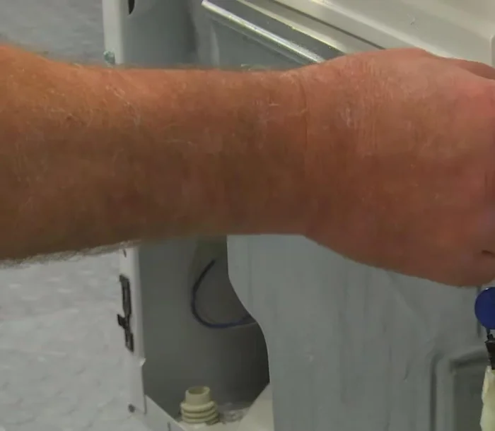 Remove the front bulkhead by removing two screws at the bottom and two on each side, then loosening two at the top.