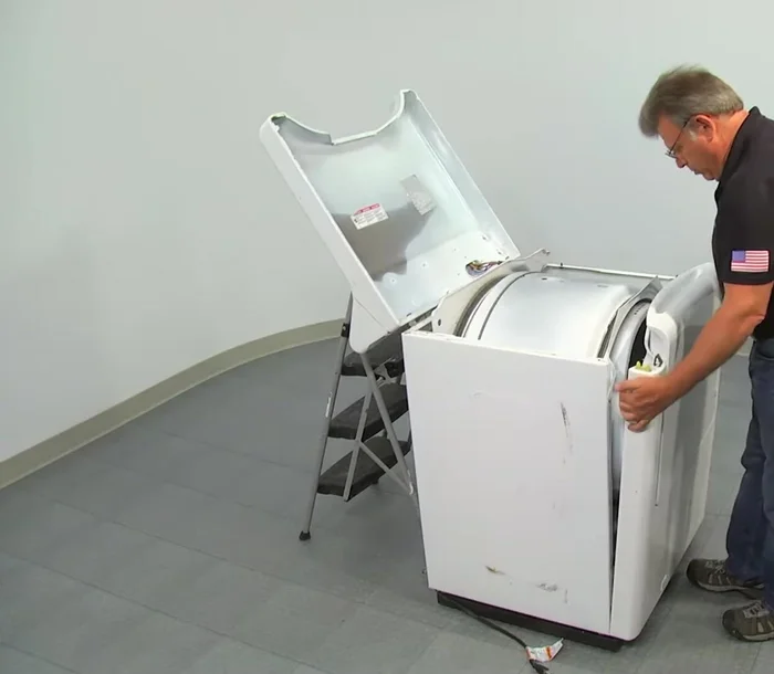 Remove the front panel by tilting it back and pulling it up from the mounting clips.