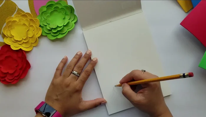 Glue golden glitter paper to the center of each flower.