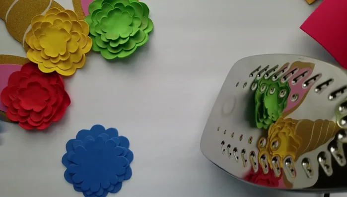 Glue golden glitter paper to the center of each flower.