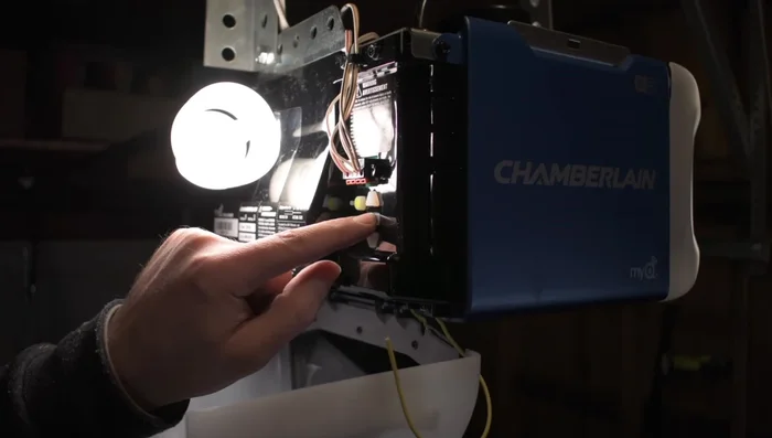 Press the middle learn button on the garage door opener once to initiate programming. The opener will beep.