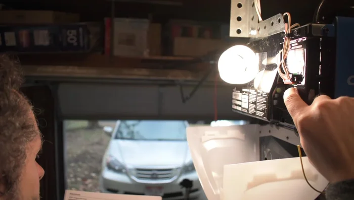 Press and hold the down button until the garage door reaches your desired opening point. Press the middle learn button again. The down arrow will blink orange/red.