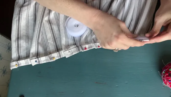 Attach the fuzzy side of the velcro to the back of the pleated fabric and pin in place.