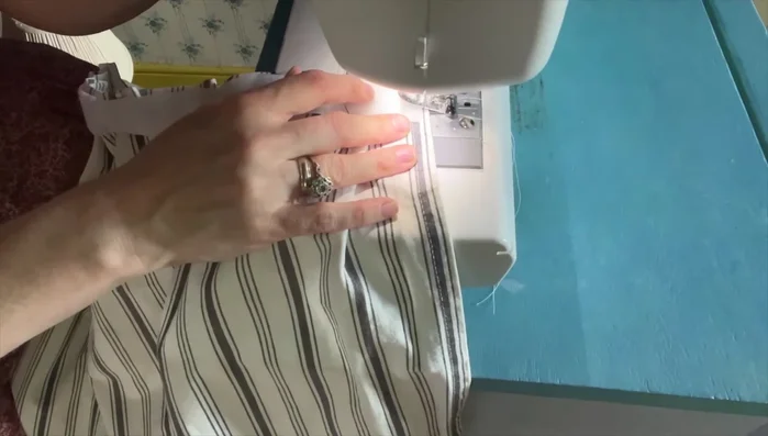 Sew the pleats and velcro to the fabric using a sewing machine. Remove pins as you sew.