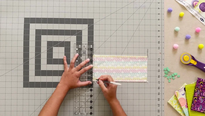 Attach pockets 1 and 2 to the organizer: Mark a line, place pockets, sew, and flip.