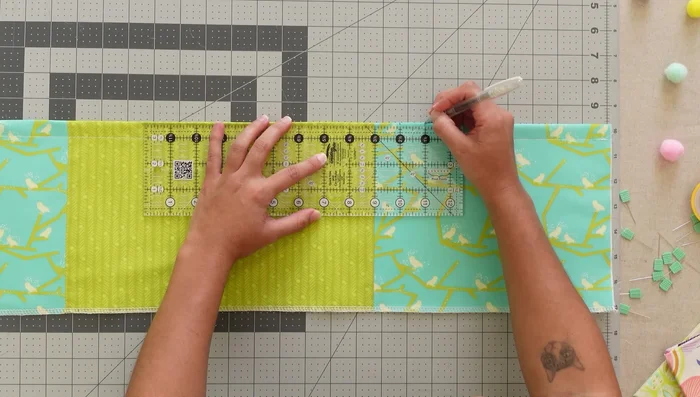 Attach the middle pocket unit: Place, sew, and stitch in the ditch.