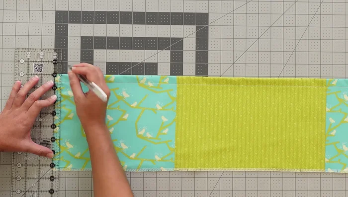 Attach the middle pocket unit: Place, sew, and stitch in the ditch.