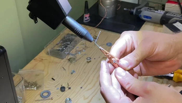 Lay out the legs in a spidery shape to check angles and symmetry before welding.