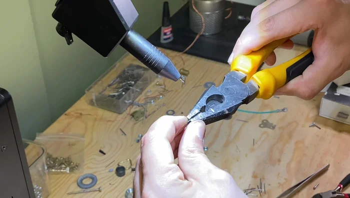 Lay out the legs in a spidery shape to check angles and symmetry before welding.