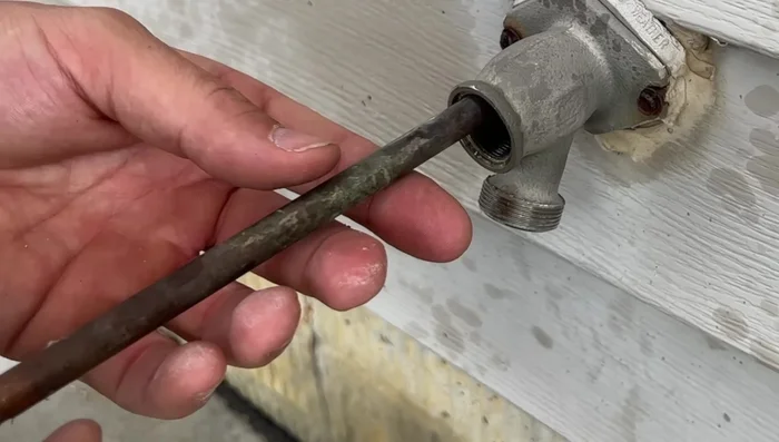 Reinstall the new flat washer onto the stem. Apply Teflon tape to the threads (optional).