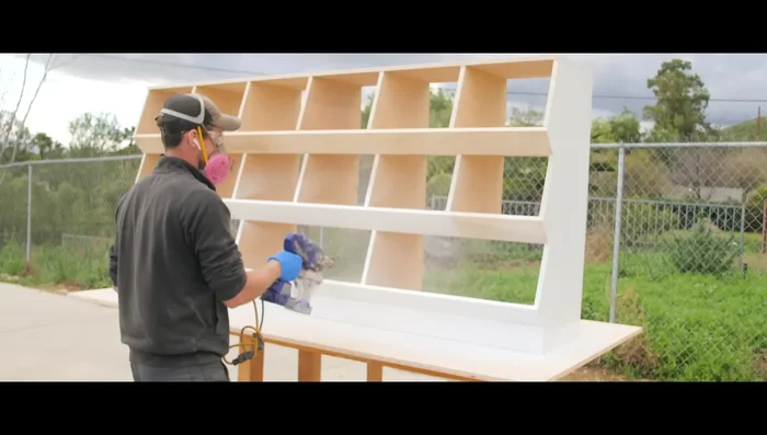 Spray several coats of wood ceiling primer and then several coats of exterior semi-gloss white paint.