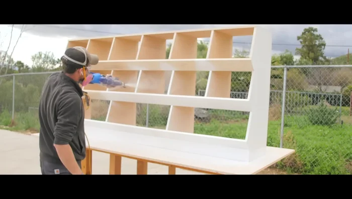 Spray several coats of wood ceiling primer and then several coats of exterior semi-gloss white paint.