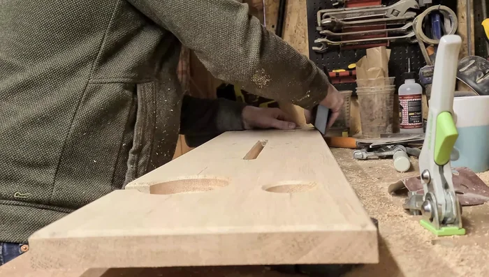 Sand: Sand with 180 grit sandpaper, focusing on any burn marks from the router. Pay extra attention to the chamfered edges.