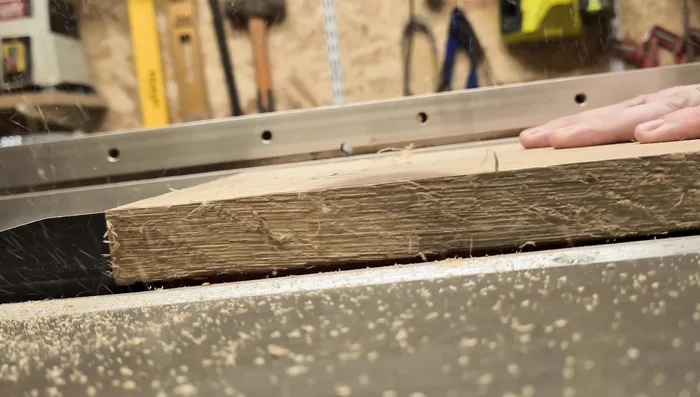 Prepare the wood: Plane both sides of the oak board. The presenter initially used a mechanical planer for efficiency, followed by a hand plane for a smooth finish.