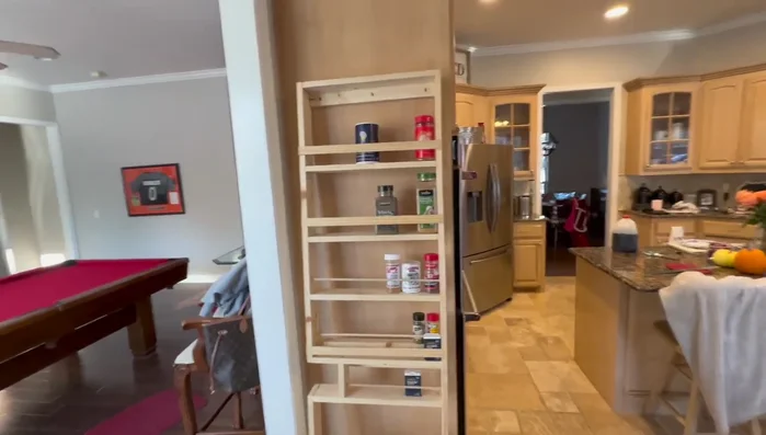 Install anchors and mount the rack: Install hollow wall anchors into the drilled holes. Attach the spice rack to the pantry door using the anchors.