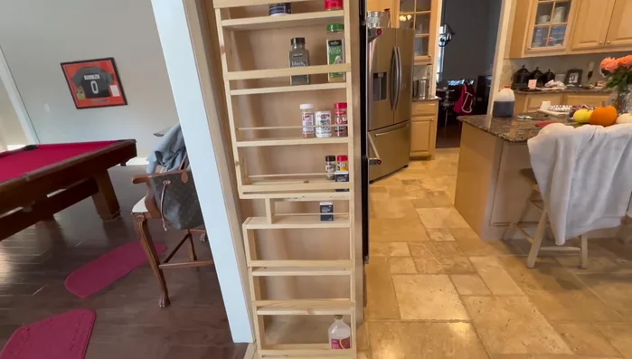 Install anchors and mount the rack: Install hollow wall anchors into the drilled holes. Attach the spice rack to the pantry door using the anchors.