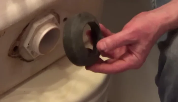 Install a new tank-to-bowl gasket and washers (from the repair kit). Use a metal washer, followed by a rubber washer, then the nut. Add an extra metal washer for added security.