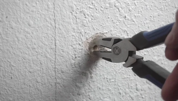 Remove the offending nail or screw. Use pliers and leverage to remove nails; for screws, use a drill.