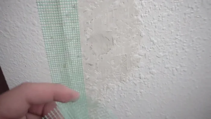 Apply mesh tape over the filled area to reinforce the repair.
