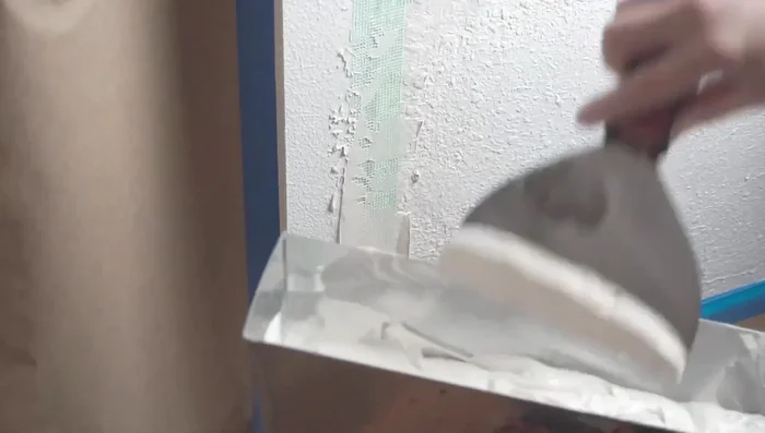 Apply a second coat of a slower-setting joint compound (20, 45, or 90-minute) over the mesh tape to create a smooth, even surface.