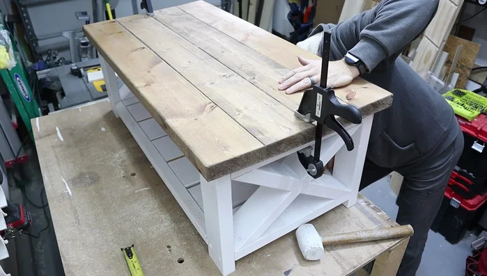 Attach the table top to the base using screws and pre-drilled holes.
