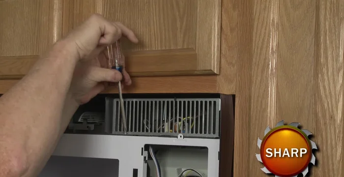 Remove the screw to release the access grill. Use a screwdriver to pry out the old fuse.