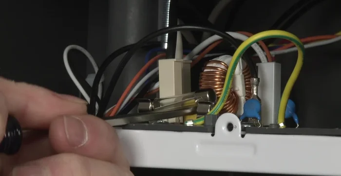 Install the new fuse by snapping it into place on the noise filter board.