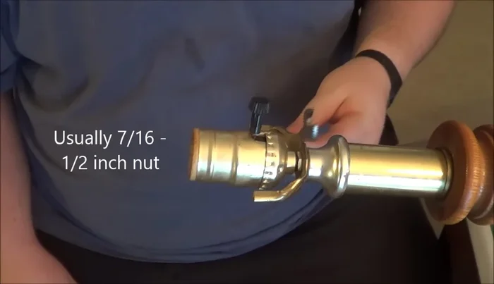 Unscrew the old lamp socket from the lamp's central rod using a wrench. If the socket is difficult to reach, remove the switch first.