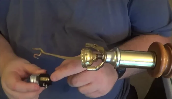 Reassemble the lamp, securing the new socket to the central rod and reattaching the base.