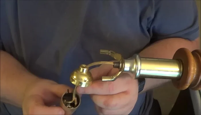 Reassemble the lamp, securing the new socket to the central rod and reattaching the base.