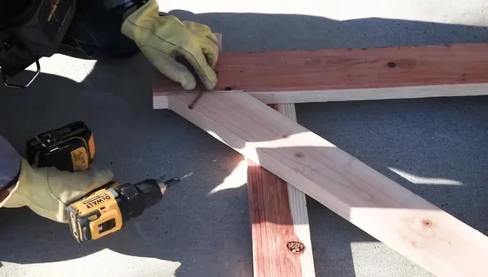 Attach the rails to the diagonal brace using 4" screws. Pre-drill to prevent splitting.