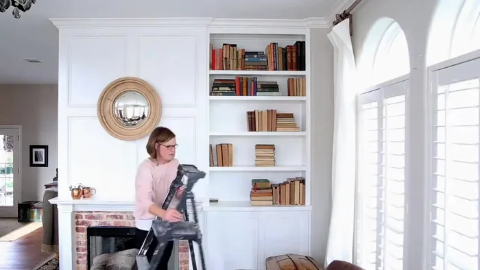 Arrange books: Re-arrange books, focusing on creating visual balance and height consistency (similar height books grouped together). Consider the functional aspect - keeping frequently used books easily accessible.