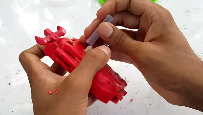 Cut down a pen body to fit securely onto the launcher's white prong. Secure with hot glue for a stronger bond.