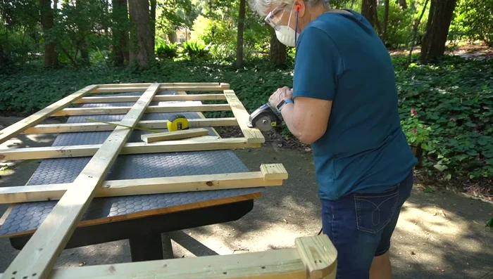 Prepare box spring base: Cut and attach additional wood supports to reinforce the queen-size box spring using glue and brads. (Consider extending supports slightly beyond the existing frame for better bed fit).