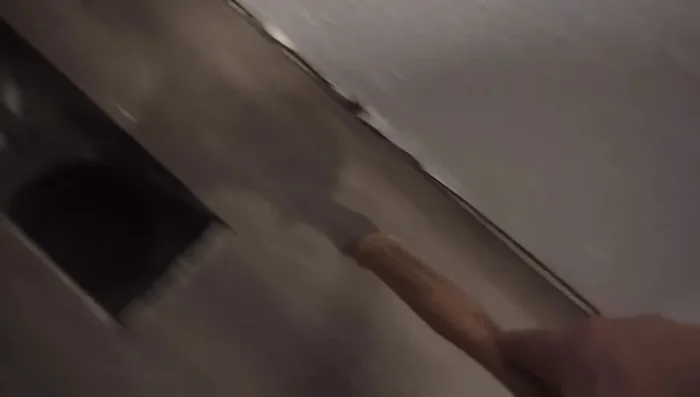 Apply masking tape along the edges of the damaged area to protect surrounding planks.