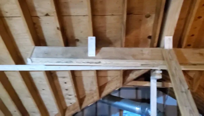 Installing 2x8 support beam to correct the sag.