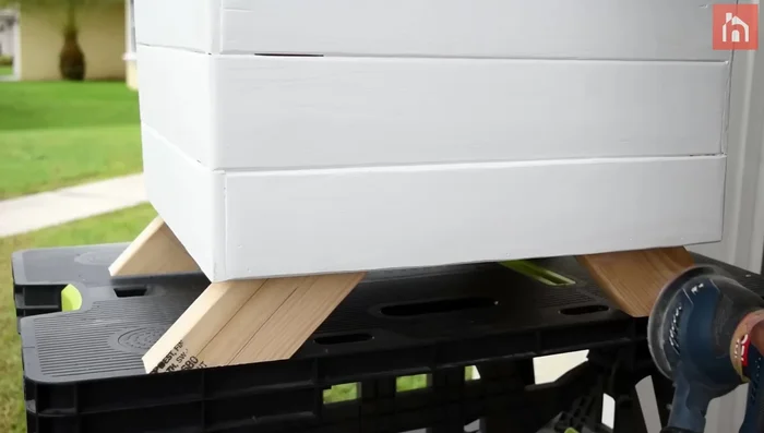 Sand the legs and apply a coat of clear polyurethane.